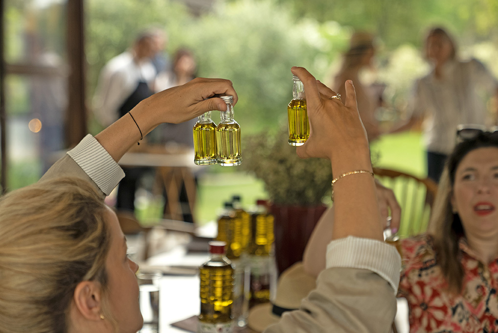 One lady holding three bottles of oil